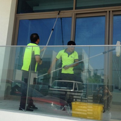 A group of people cleaning a balcony