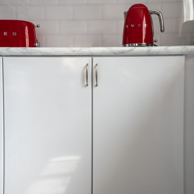 A red kettle in a kitchen