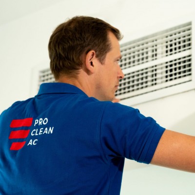 A member of the Pro Clean AC team removing an AC grille to clean it